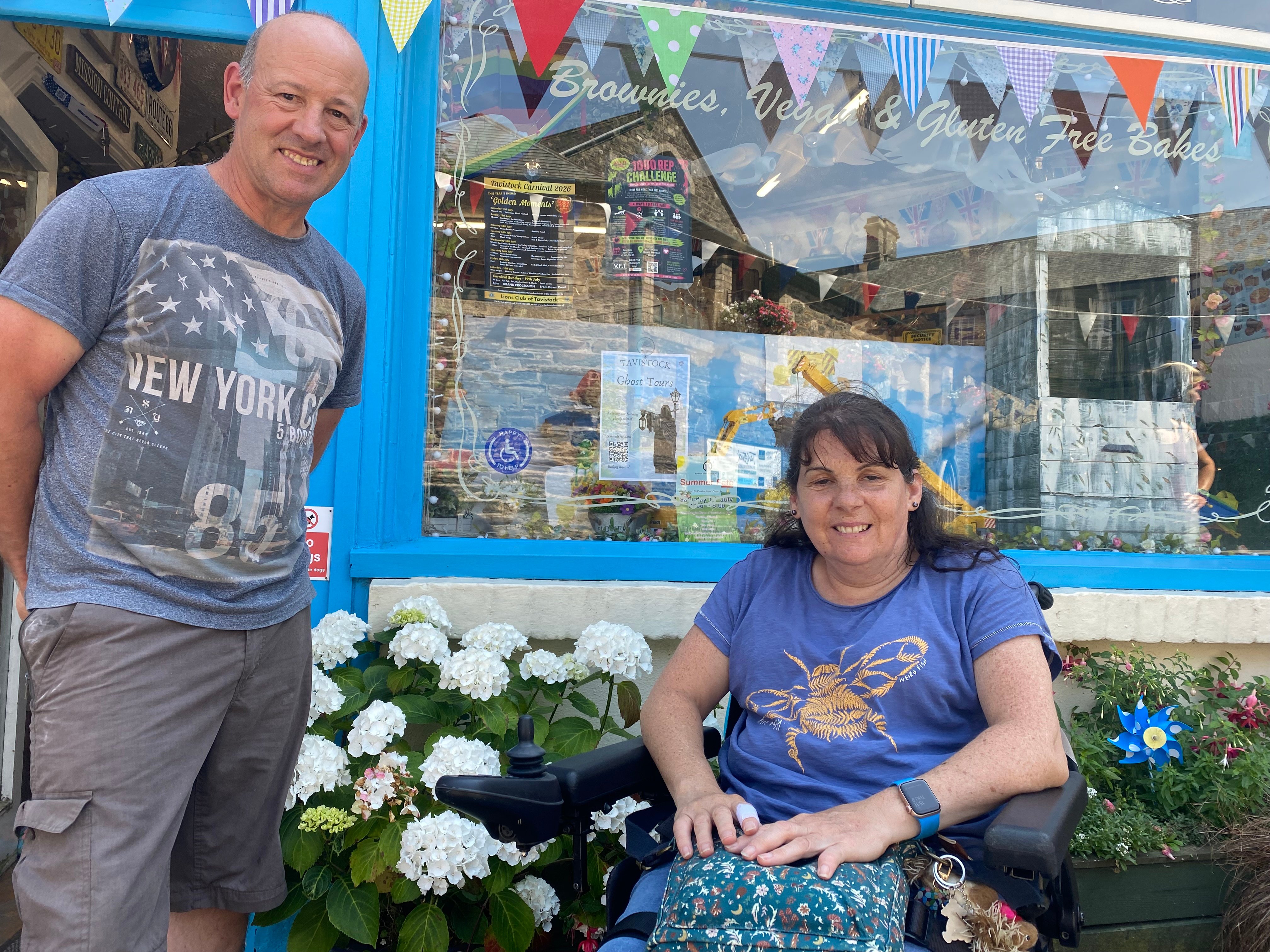 Tina Willcocks, of Tavistock, has launched a successful sticker campaign to highlight shops with mobility access. She is pictured outside Dot's Health Foods with Phil King.