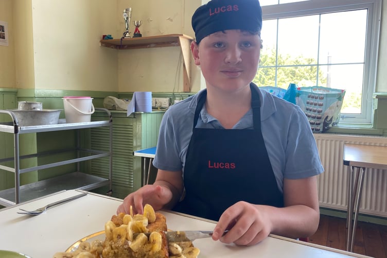 Lucas taste testing his banana bread cake he cooked for Princetown School's bake-off competition.