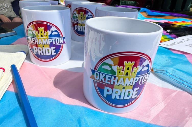 Okehampton Pride merchandise was for sale. AQ 5730