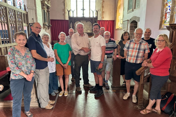 Reverend Jeremy Putnam, centre right, was welcomed to Colebrooke Parish Church by a good crowd during his walking challenge. AQ 7272