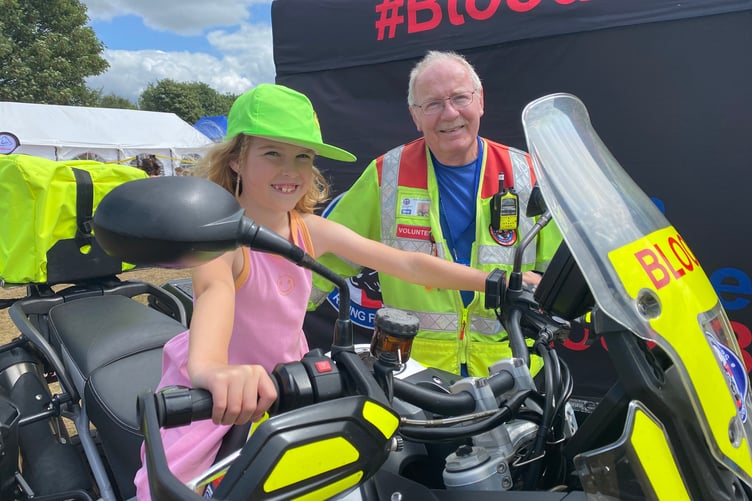 Genevieve, 8, in the driving seat of Devon Freewheelers motorbike blood delivery service at Yelverton Rotary Club free family fun day.