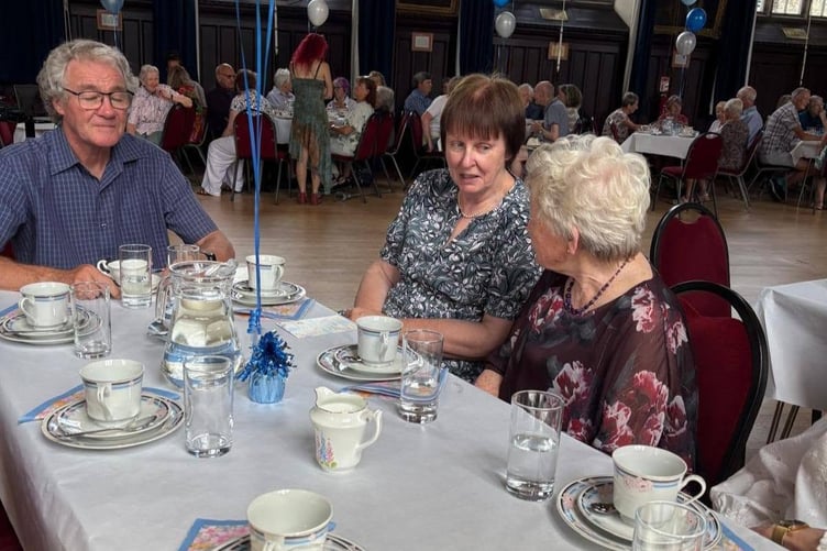 Tavistock Memory Cafe carers, family, volunteers and guest, including town Mayor Cllr Anne Johnson (second left) celebrated its twentieth year with a party in Tavistock Town Hall.