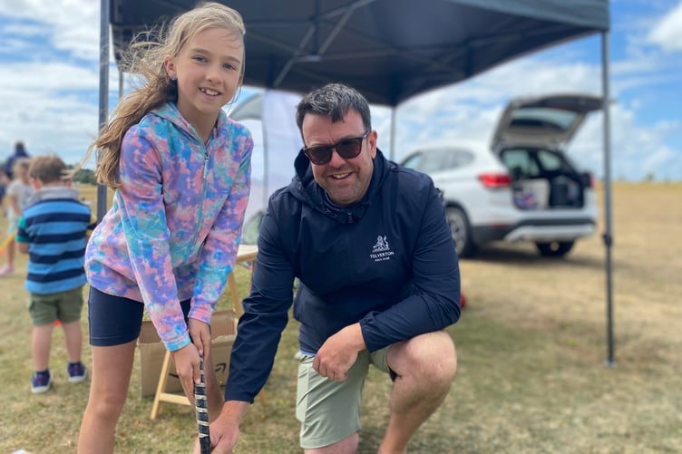 Olivia, 9, gets to grips with a golf club under the eye of a Yelverton Golf Club professional coach at Yelverton Rotary Club Family Fun Day.