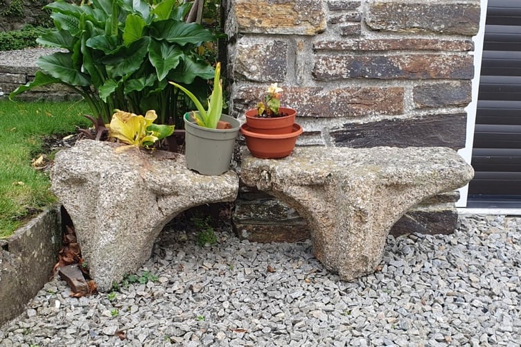 Two pieces of granite stonework from the former Tavistock Abbey have a new more prosaic role as plant pot stands in a private garden.