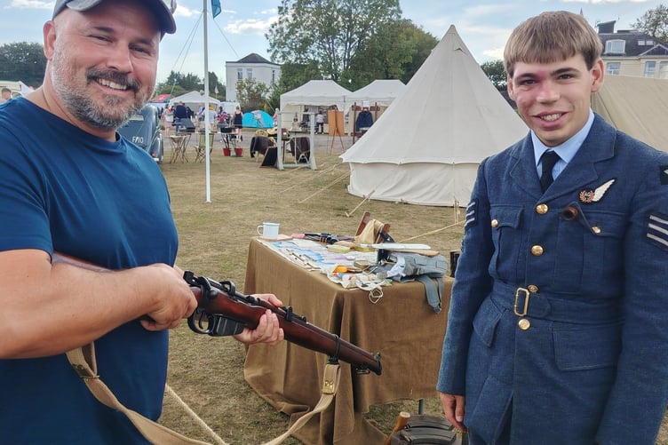 A visitor to RAF Harrowbeer 1940s Weekend is shown how a WWII rifle works.