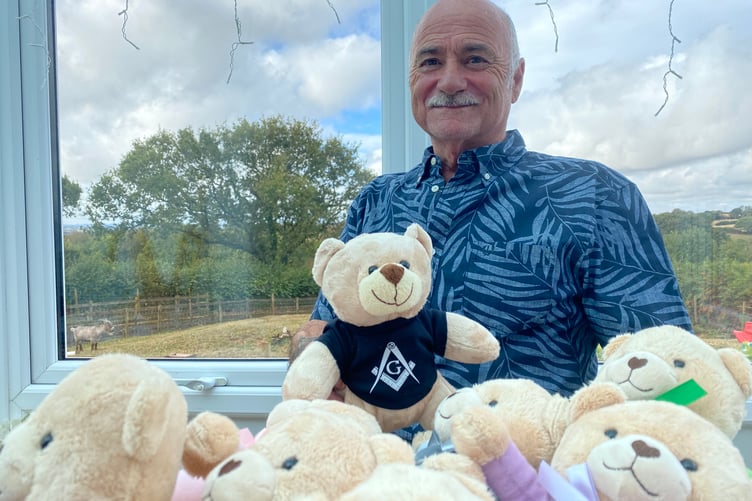 Collytown farmer Arthur Blamey recovering at home after his bad accident. He is holding one of the hundreds of toy bears he distributes, as a Freemason, to children in hospital.