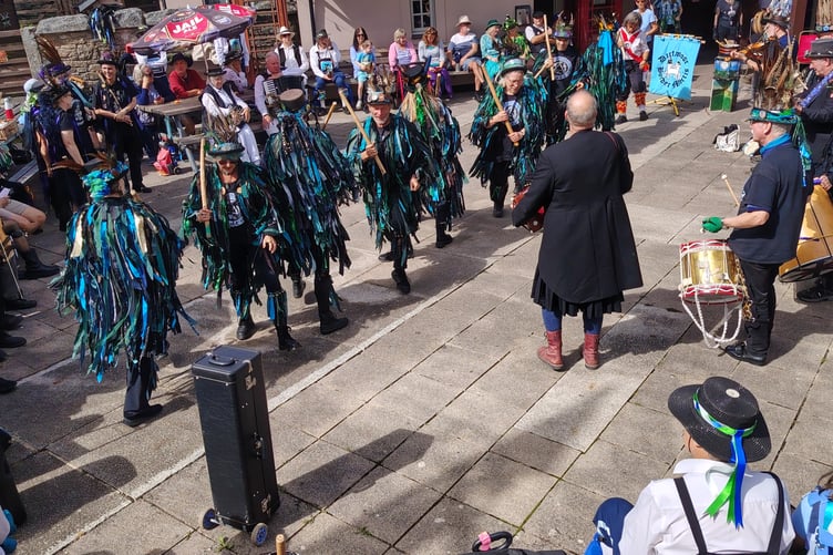 The air was full of the banging of sticks and drums and the jingle of bells as morris groups entertained Princetown crowds at the mass celebrations of Border Morris group's 25 years.