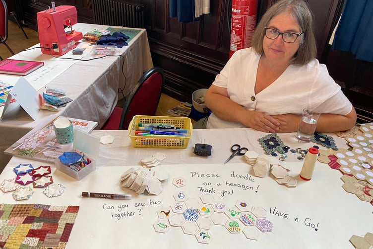 Visitors can contribute their own designs to a quilt to mark the Goosey Quilters' fortieth anniversary at the community needleworkers' exhibition in Tavistock Town Hall.