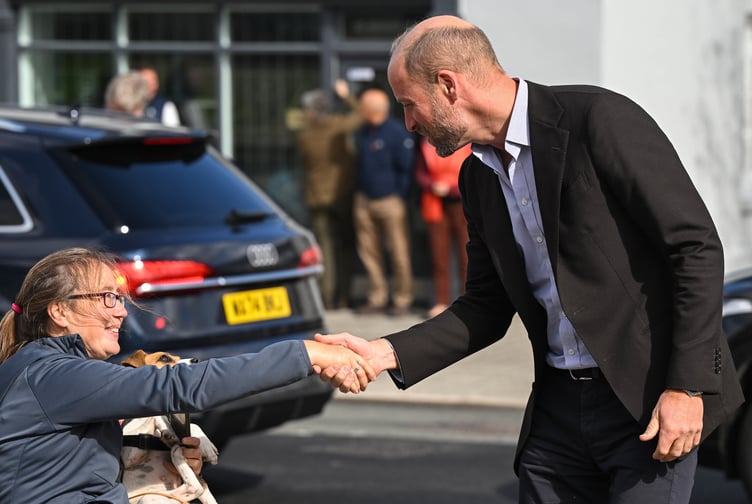Prince William greets a resident who has come to meet him as he visits Princetown today, Tuesday, September 15
