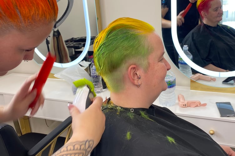 Jen Powers-Horn, Tavistock shop worker undergoing her traffic lights hairdo in aid of charity, at Gypsy Glow beauty salon with stylist Nasha Wall.