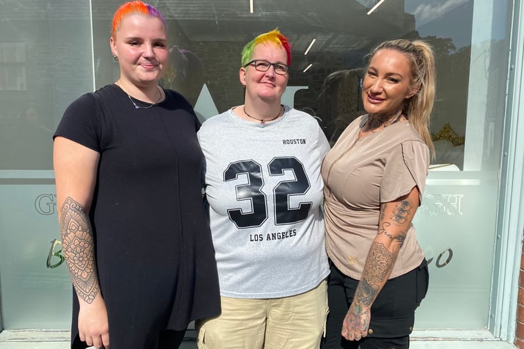 Jen Powers-Horn, centre, outside Gypsy Glow beauty salon with stylist Nasha Wall, left, and Amber-Leigh Langdon-Parsons (owner). Jen's hair is green, yellow and red for charity.