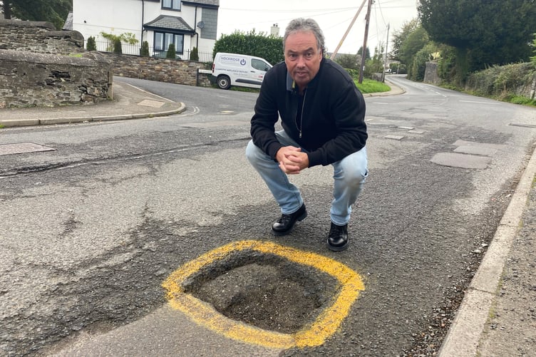Dave Newcombe, Tavistock's Mr Pothole pothole, is pictured at a blackspot on Butcher's Hill.