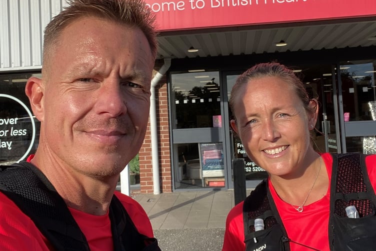 Royal Mail managers Paul Davies and Leesa Grainger stop off at the Plymouth British Heart Foundation store on their way to the city mail sorting office to finish their 100km run in aid of the charity.