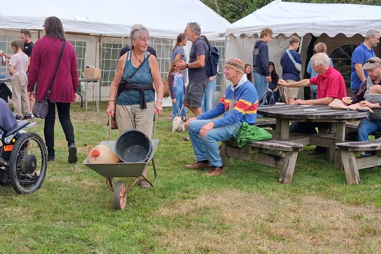 A crowd enjoys Bere Apple Fest, drinking and making apple juice and watching a sea shanty group and a morris dance troupe.