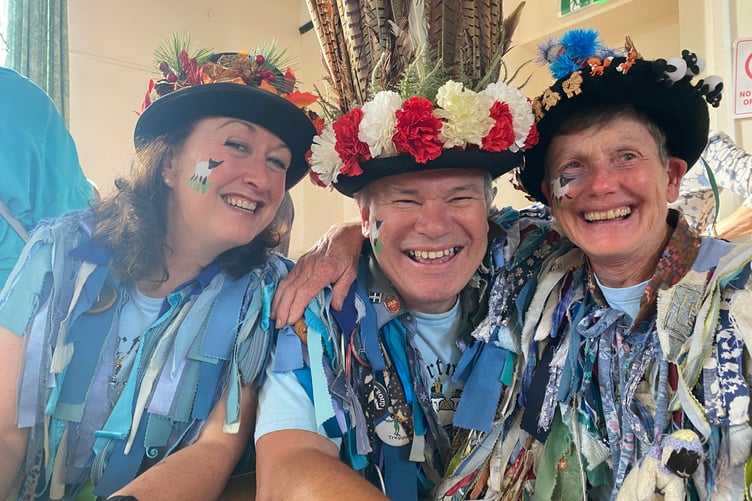 Three members of Dartmoor Border Morris relax at Bere Apple Fest.