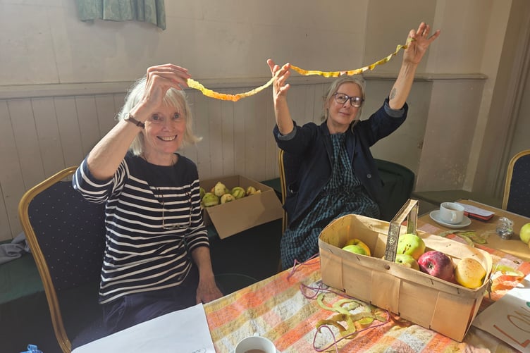 An apple-peeling competition at Bere Apple Fest creates an impressive long result. Photo by Ann Parsons.