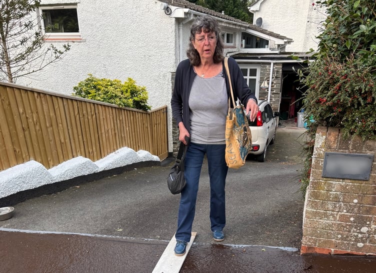 Cathy Hipsey negotiating sticky tar patch outside her house.
