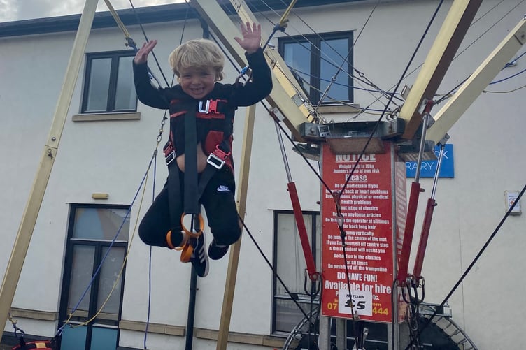 Arthur Langdon, 4, jumps for joy on a fairground ride next to Tavistock Library at Tavistock Goose Fair.