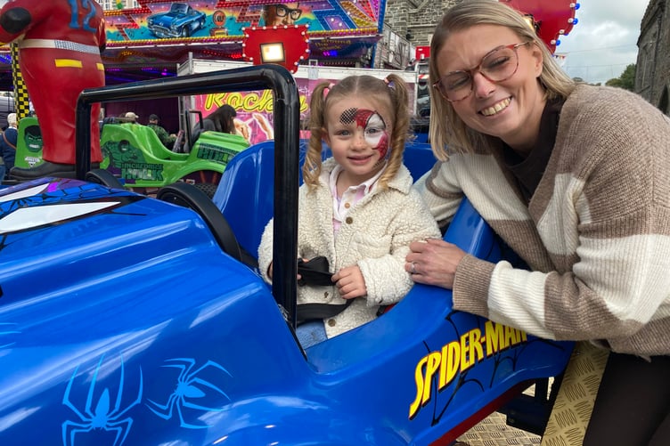 Niamh Brenton, 3, sitting pretty in a Spiderman themed car and Spiderman face paint with her mum Sian. Niamh enjoyed the Tavistock Goose Fair fair ride.