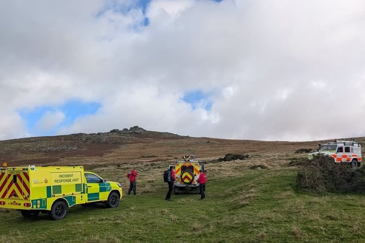Crew waiting for the injured runner to be brought down off the tor on a stretcher.